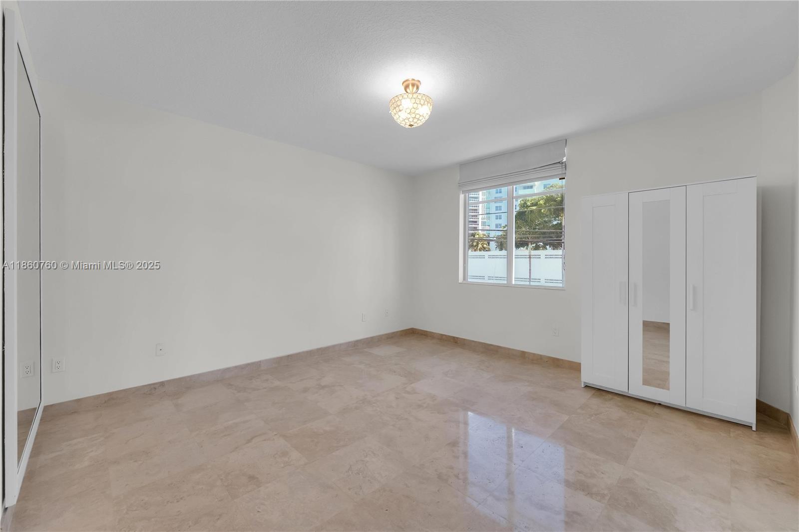 1 Century Lane, Unit 202 Miami Beach, FL 33139 - Photo 16 of 28 an empty room with windows and closet