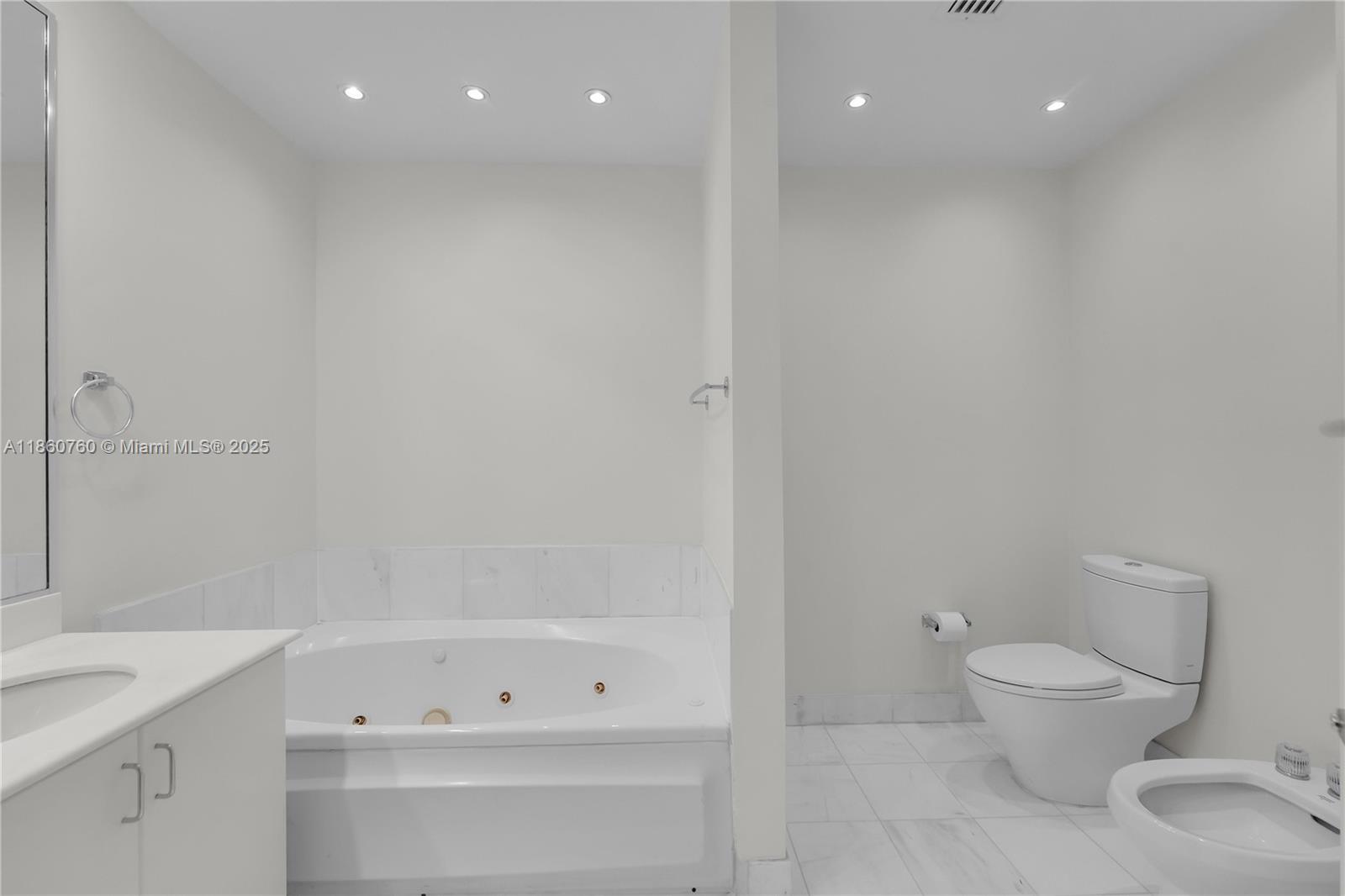 1 Century Lane, Unit 202 Miami Beach, FL 33139 - Photo 19 of 28 a bathroom with a toilet a sink and bathtub