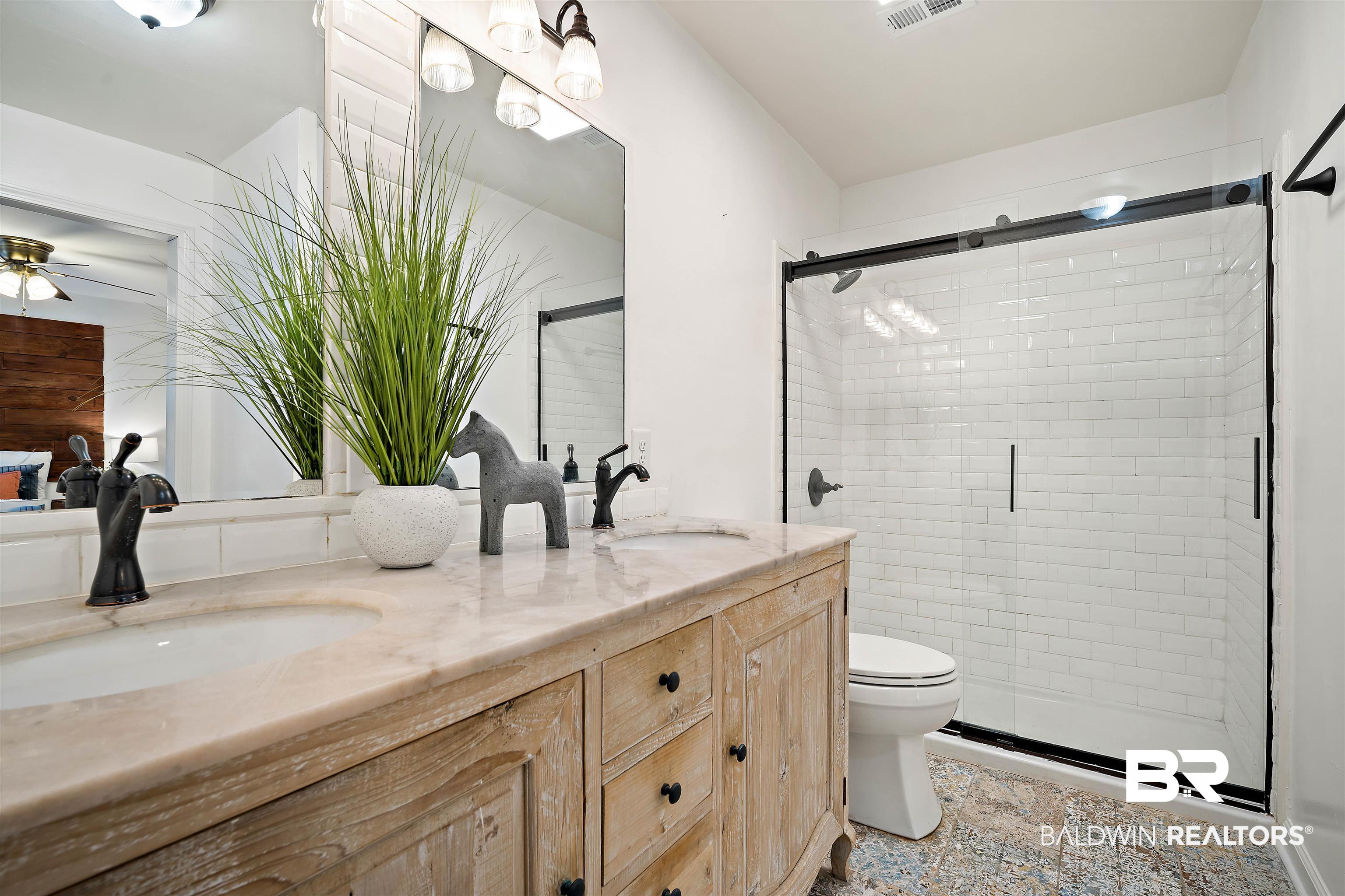 2615 Walton Avenue Mobile, AL 36606 - Photo 21 of 33 Bathroom featuring a stall shower, a sink, and double vanity