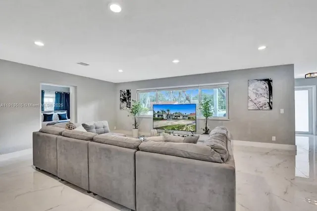 a view of a livingroom with furniture and a mirror