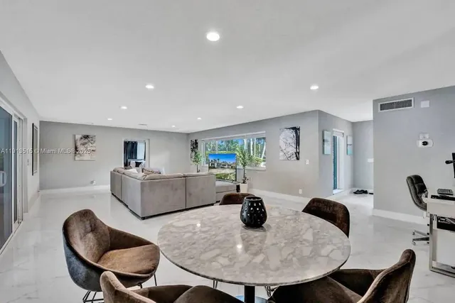 a kitchen with stainless steel appliances kitchen island granite countertop a sink and cabinets