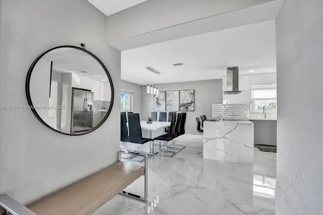 a kitchen with stainless steel appliances a refrigerator and a cabinets