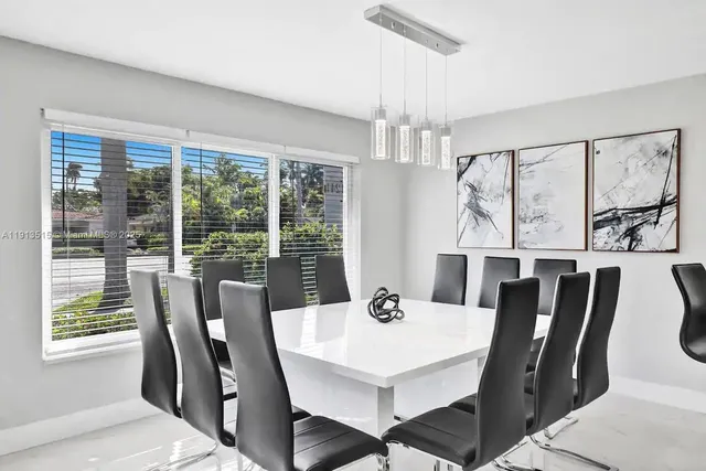 a bedroom with two beds and a large window