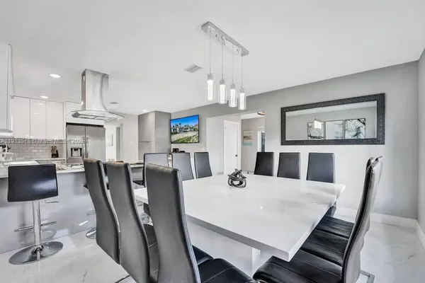 a kitchen with stainless steel appliances a refrigerator and a cabinets