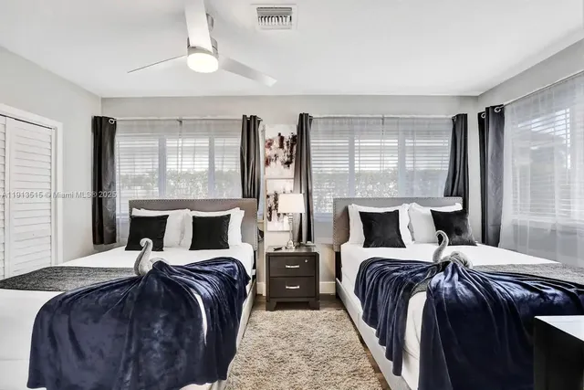 a bedroom with a large bed and a chandelier