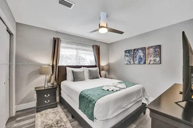 a bathroom with a sink a toilet a mirror and shower