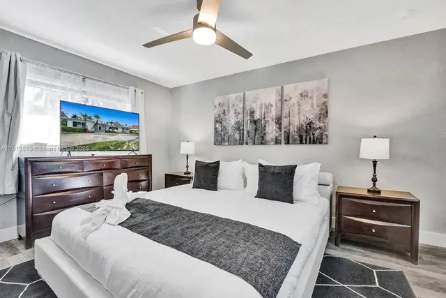 a en suite bathroom with a granite countertop toilet and a mirror