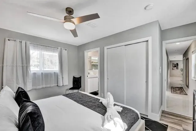 a bedroom with a bed and a painting on the wall