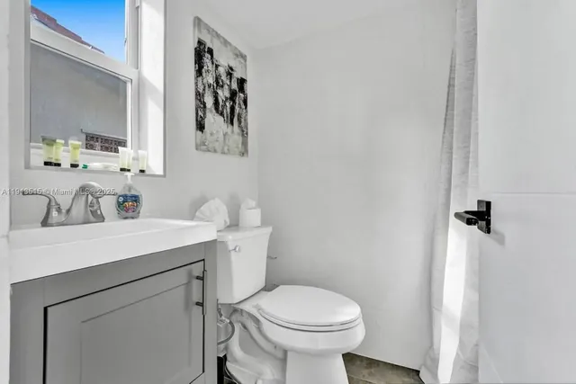 a childrens park with lots of swings and slides and pool in the back