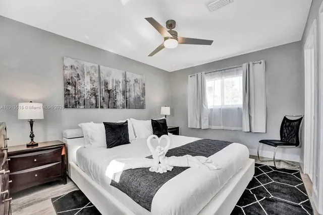 a front view of a house with a yard and palm trees