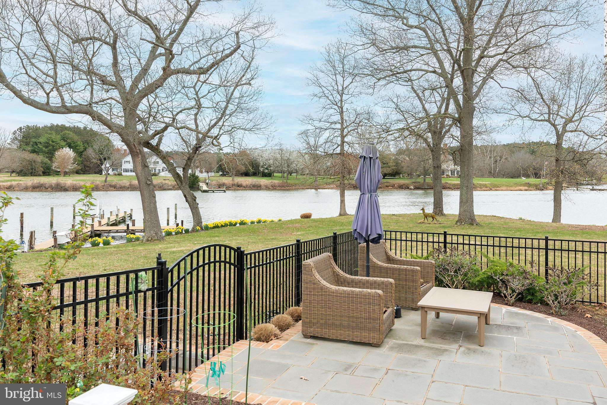 4752 Sailors Retreat Road Oxford, MD 21654 - Photo 7 of 22 a view of a patio with two couches chairs and a floor to ceiling window