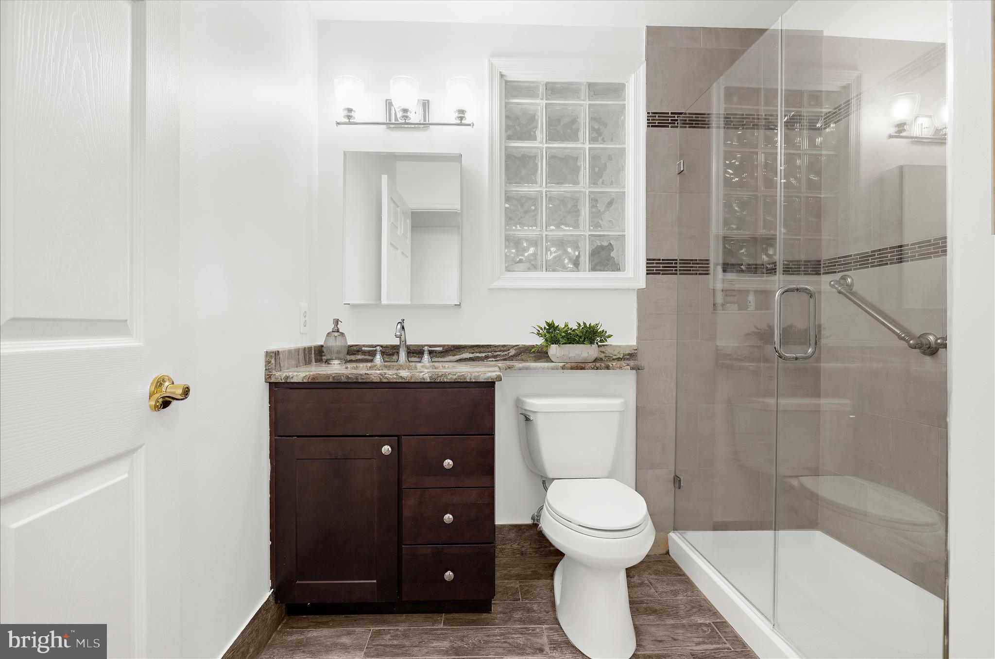 360 Hoile Lane Huntingtown, MD 20639 - Photo 64 of 96 a bathroom with a granite countertop sink toilet a mirror and shower