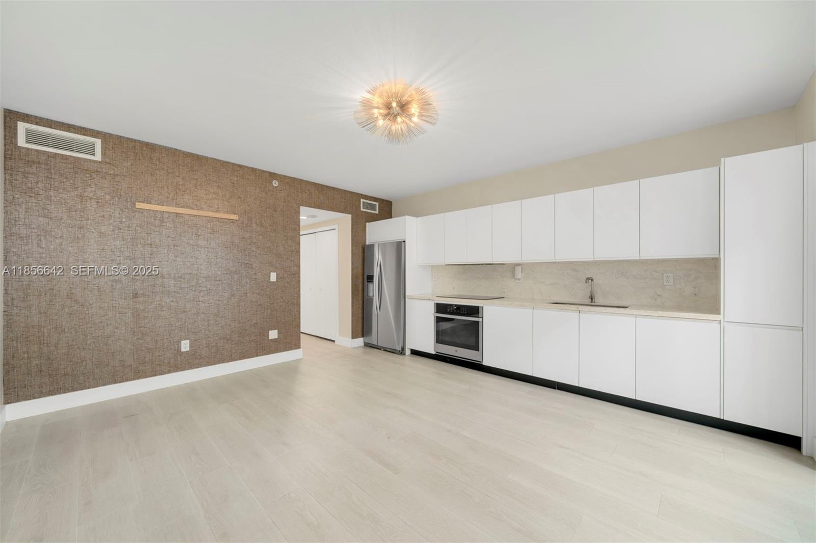 435 21st Street, Unit 103 Miami Beach, FL 33139 - Photo 15 of 20 a view of a kitchen with a sink dishwasher and a microwave oven in a kitchen