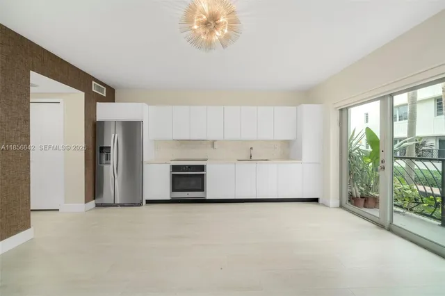 a view of a kitchen with a sink dishwasher and a fireplace