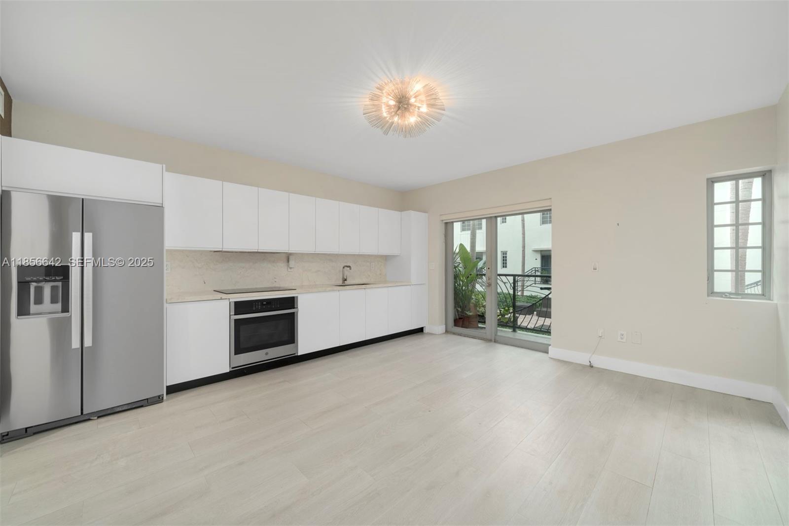 435 21st Street, Unit 103 Miami Beach, FL 33139 - Photo 17 of 20 a view of a kitchen with a sink dishwasher and a fireplace
