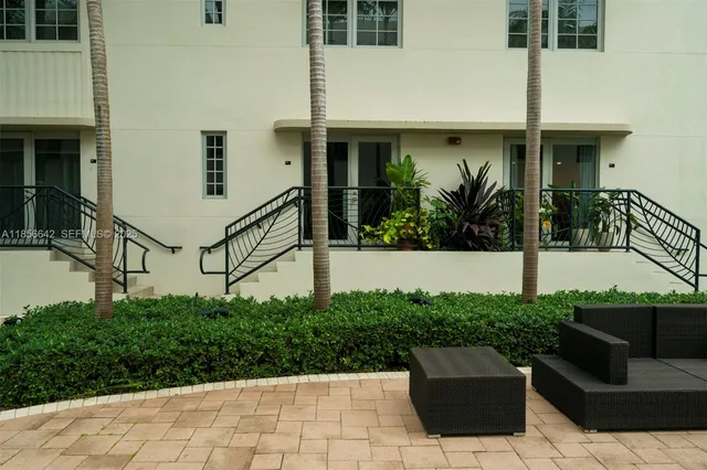 a view of a garden with tall buildings