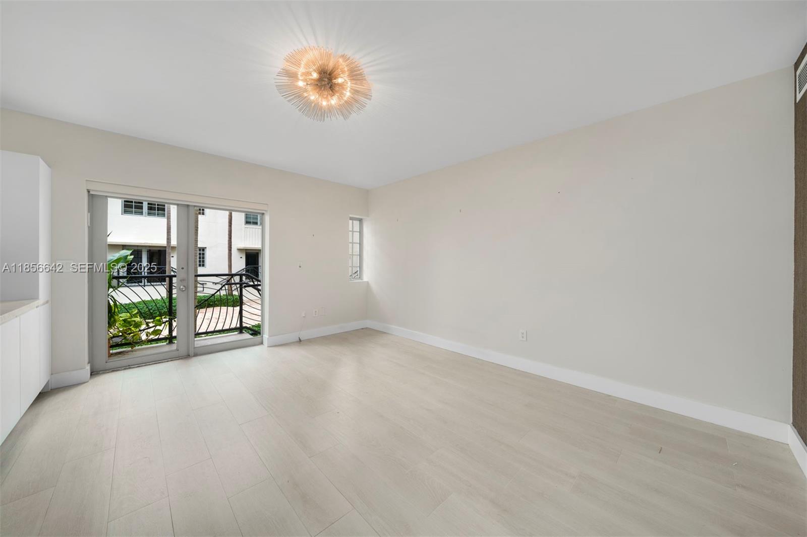 435 21st Street, Unit 103 Miami Beach, FL 33139 - Photo 2 of 20 a view of an empty room with a window