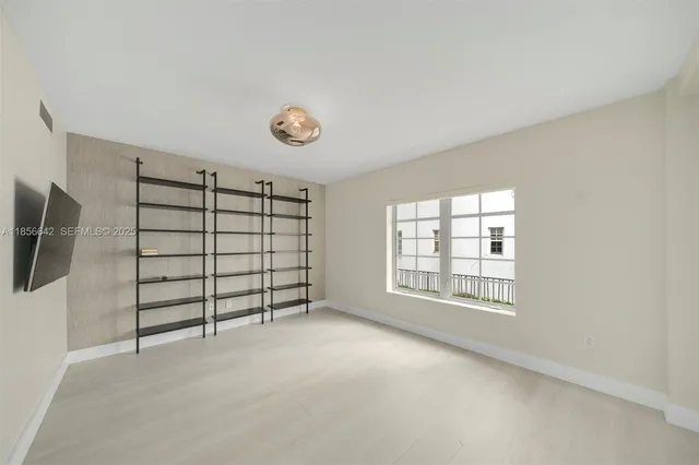 an empty room with a empty space and windows