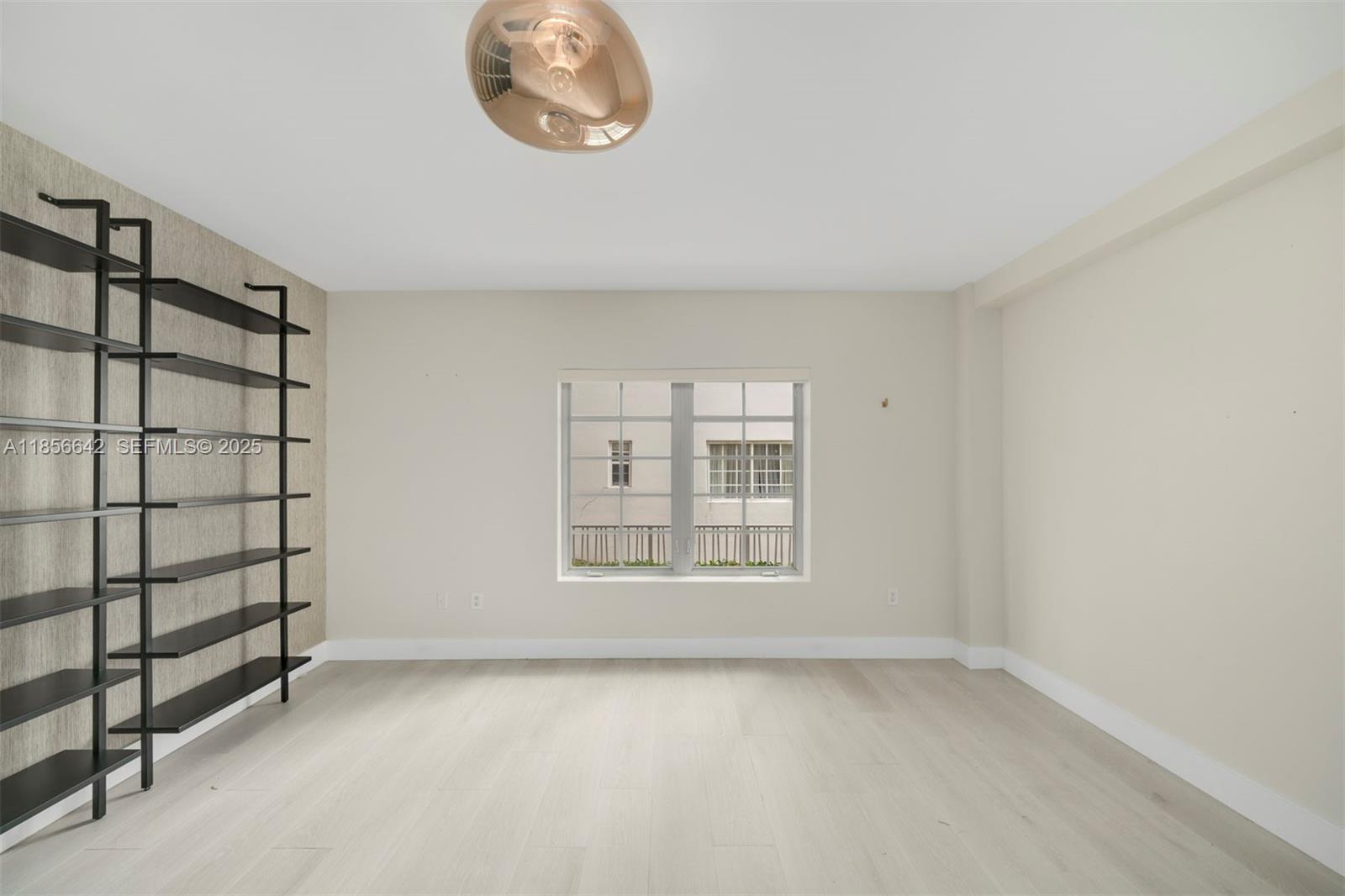 435 21st Street, Unit 103 Miami Beach, FL 33139 - Photo 4 of 20 an empty room with a empty space and window