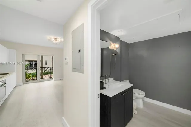 a bathroom with a sink toilet and mirror