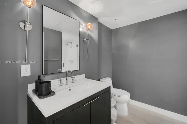 a bathroom with a sink toilet and shower