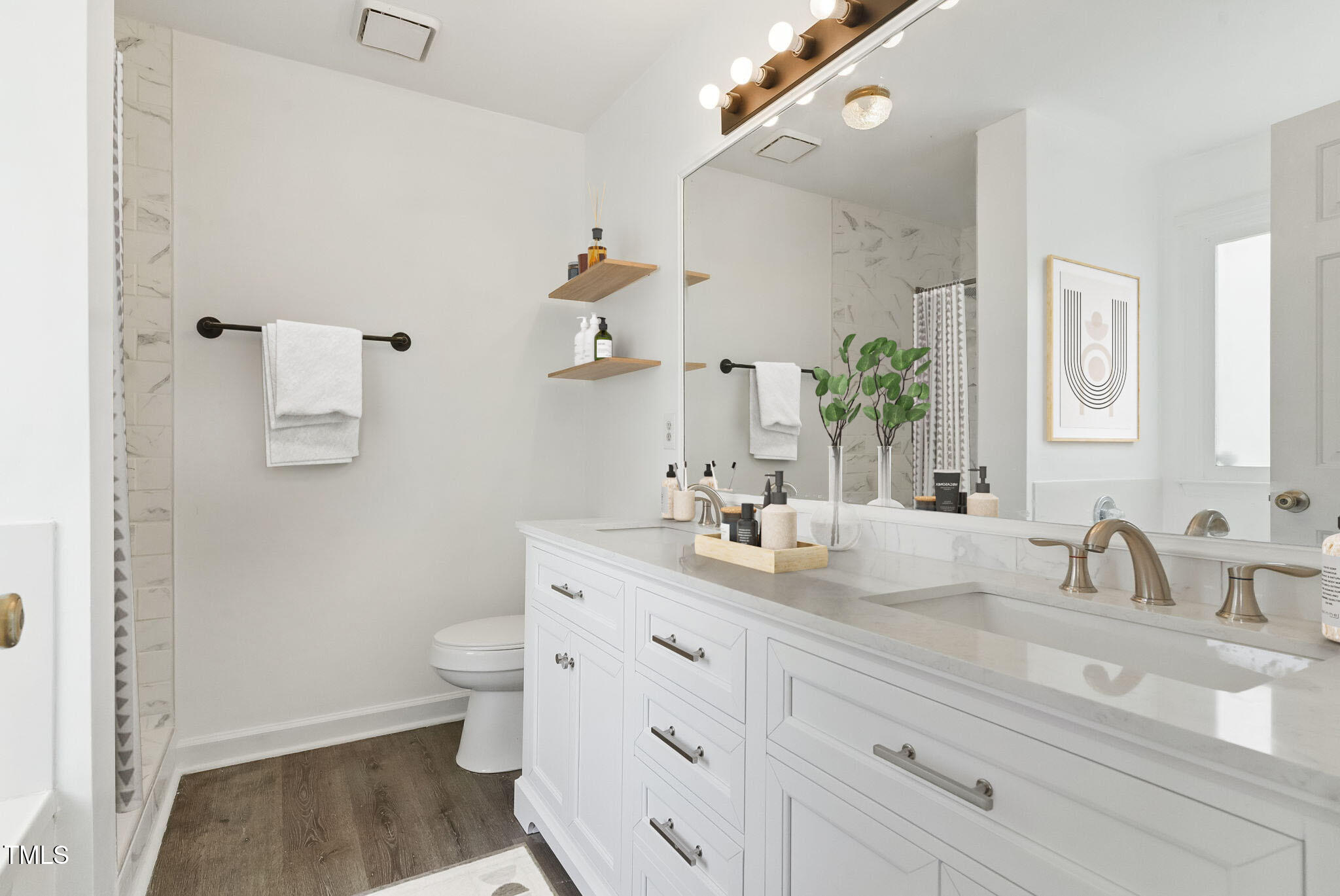 a bathroom with a sink a toilet and a mirror