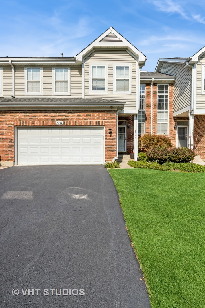 7324 Chestnut Hills Drive Burr Ridge, IL 60527 - Photo 1 of 25 a front view of a house with a yard and garage