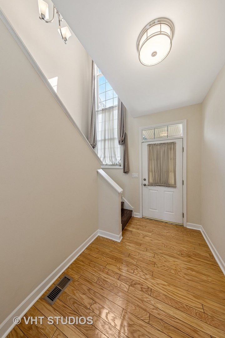 7324 Chestnut Hills Drive Burr Ridge, IL 60527 - Photo 23 of 25 a view of an empty room with wooden floor and window