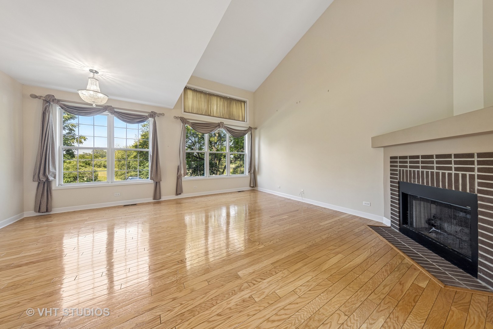 7324 Chestnut Hills Drive Burr Ridge, IL 60527 - Photo 3 of 25 an empty room with wooden floor fireplace and windows