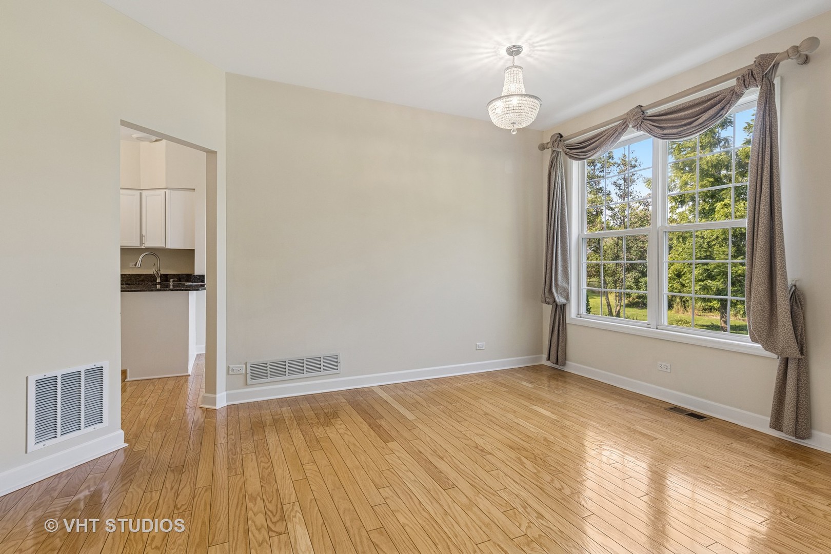 7324 Chestnut Hills Drive Burr Ridge, IL 60527 - Photo 4 of 25 an empty room with wooden floor and windows