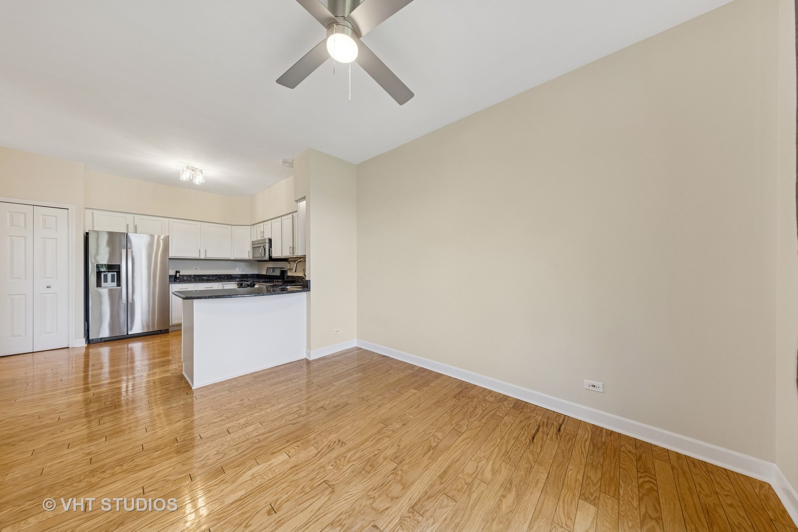 7324 Chestnut Hills Drive Burr Ridge, IL 60527 - Photo 7 of 25 a view of empty room with wooden floor and kitchen view