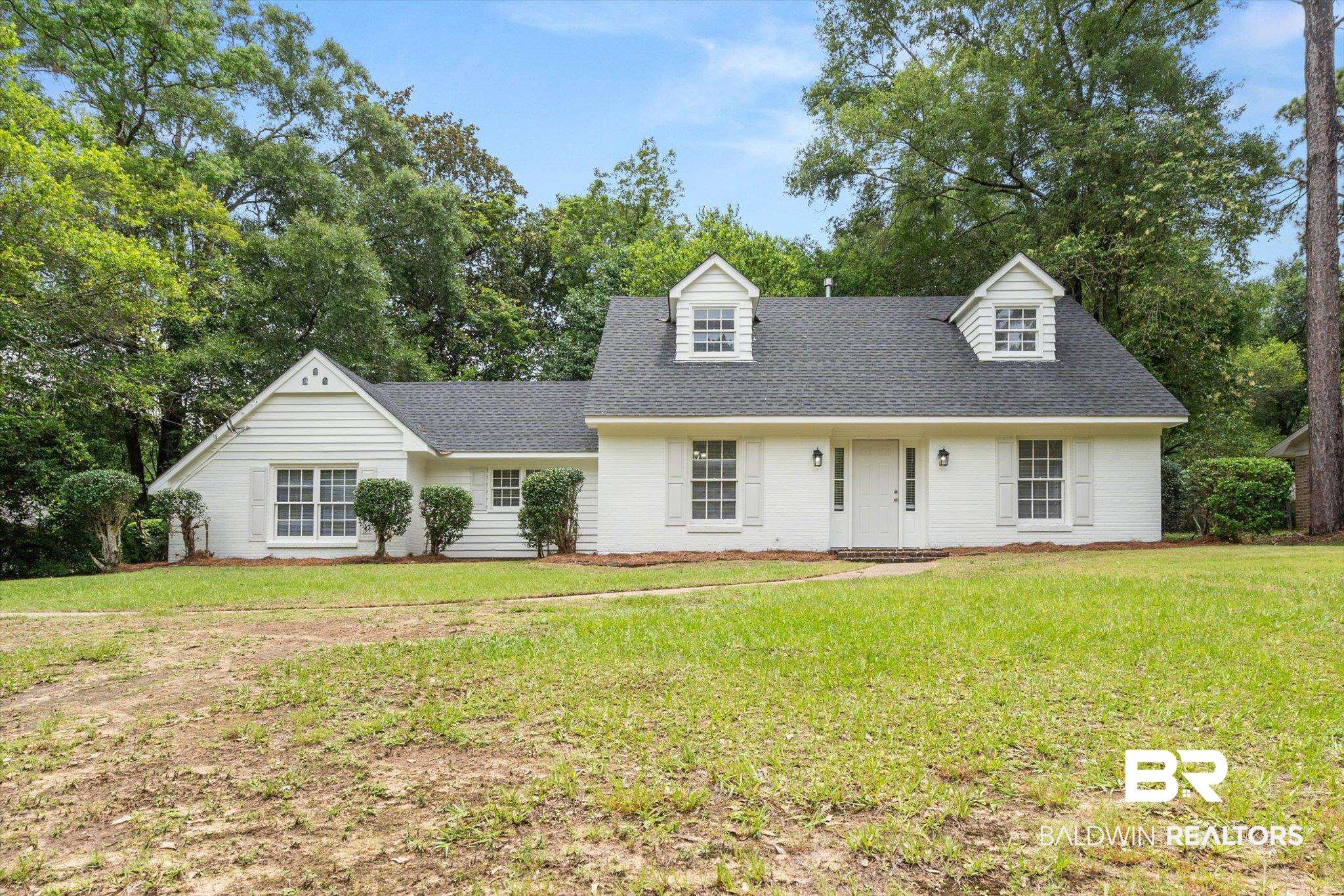 810 Nassau Drive Mobile, AL 36608 - Photo 1 of 31 View of front of house featuring roof with shingles, a front lawn, brick siding, and view of wooded area