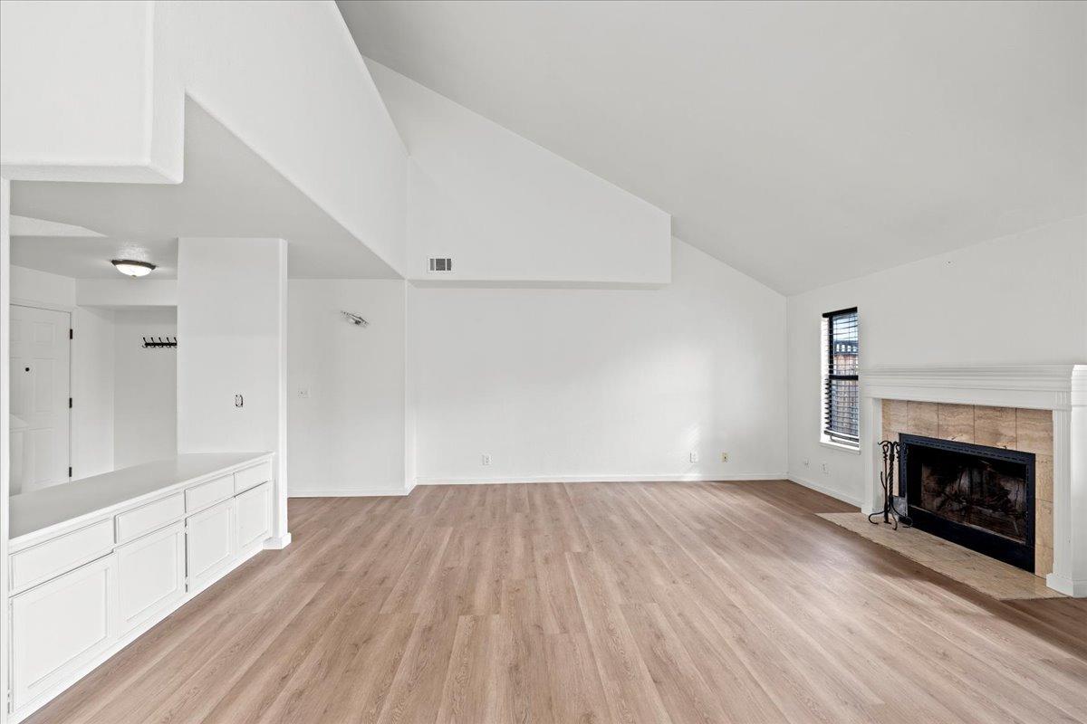 938 Snowgoose Lane Manteca, CA 95337 - Photo 4 of 16 a view of empty room with wooden floor and fireplace