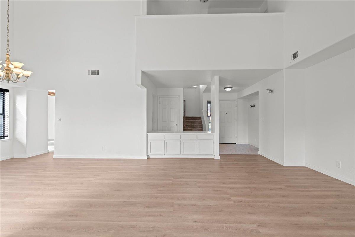 938 Snowgoose Lane Manteca, CA 95337 - Photo 6 of 16 a view of an empty room with wooden floor and a kitchen
