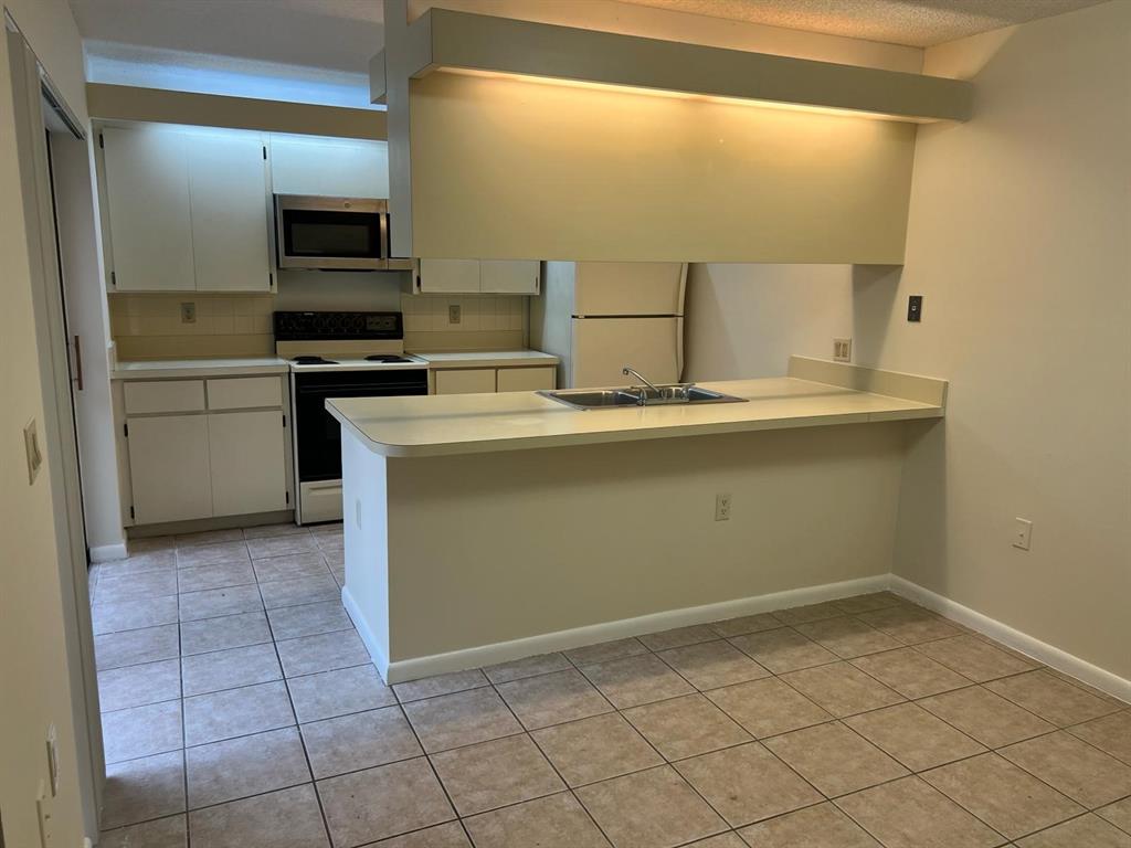 849 Blue Ridge Circle West Palm Beach, FL 33409 - Photo 15 of 28 a room with a sink cabinets and appliances