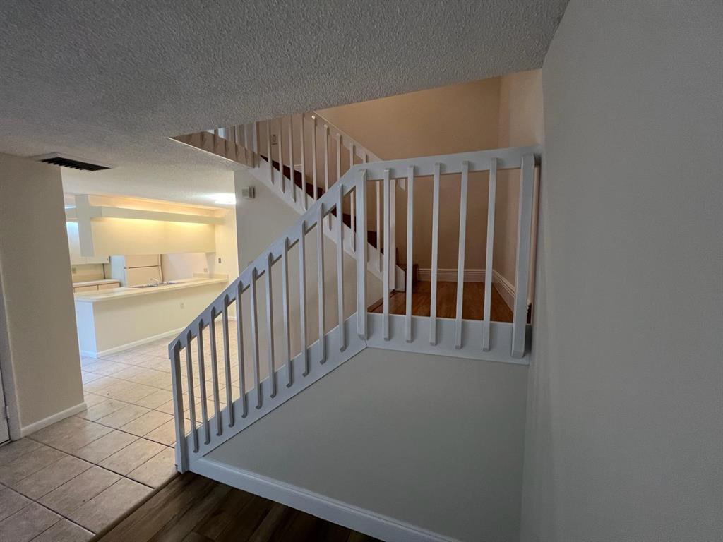 849 Blue Ridge Circle West Palm Beach, FL 33409 - Photo 24 of 28 a view of staircase with railing and white walls
