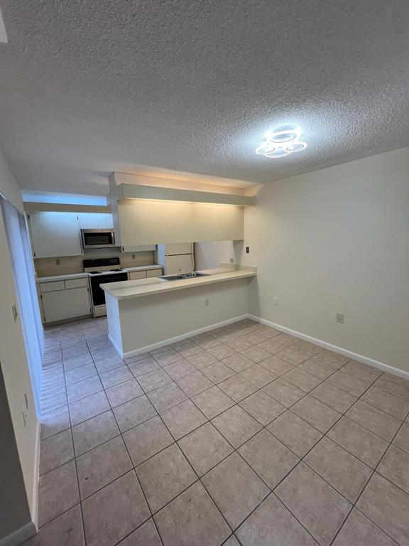 849 Blue Ridge Circle West Palm Beach, FL 33409 - Photo 8 of 28 a large white room with a large window and stainless steel appliances