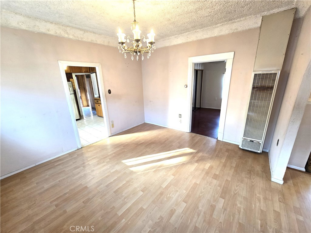 2789 Fairmount Boulevard Riverside, CA 92501 - Photo 24 of 74 a view of a chandelier in big room with wooden floor and stairs