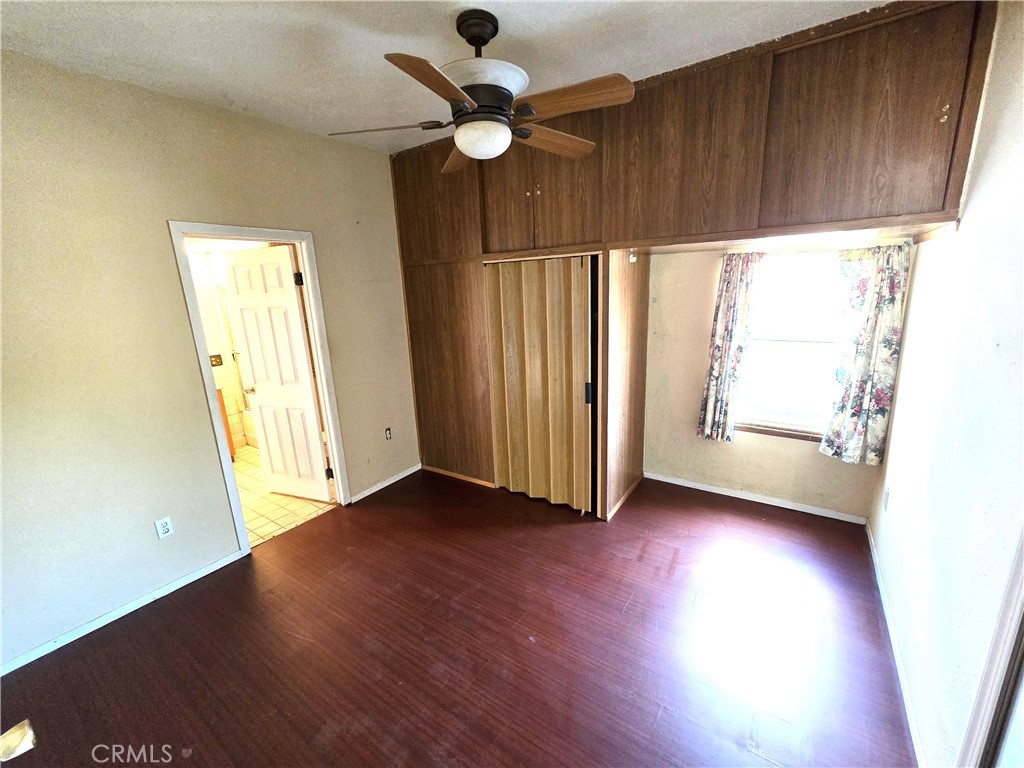 2789 Fairmount Boulevard Riverside, CA 92501 - Photo 33 of 74 an empty room with wooden floor fan and windows