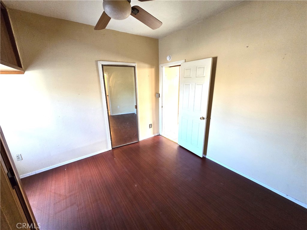 2789 Fairmount Boulevard Riverside, CA 92501 - Photo 35 of 74 an empty room with wooden floor and a ceiling fan