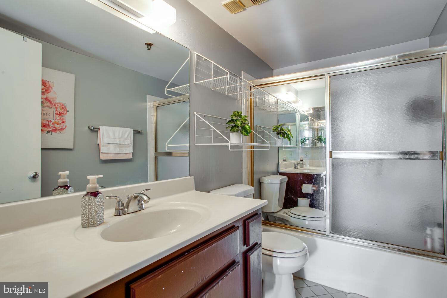5911 Edsall Road, Unit 206 Alexandria, VA 22304 - Photo 13 of 40 a bathroom with a sink toilet and shower