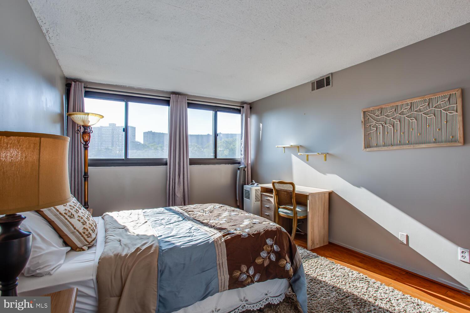 5911 Edsall Road, Unit 206 Alexandria, VA 22304 - Photo 15 of 40 a bedroom with a bed and a window