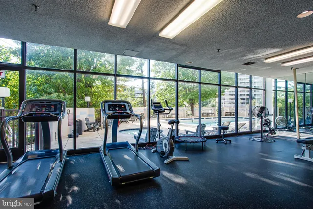 a living room with furniture and floor to ceiling windows
