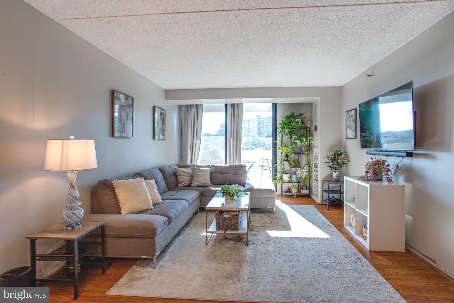 5911 Edsall Road, Unit 206 Alexandria, VA 22304 - Photo 23 of 40 a living room with furniture and a flat screen tv