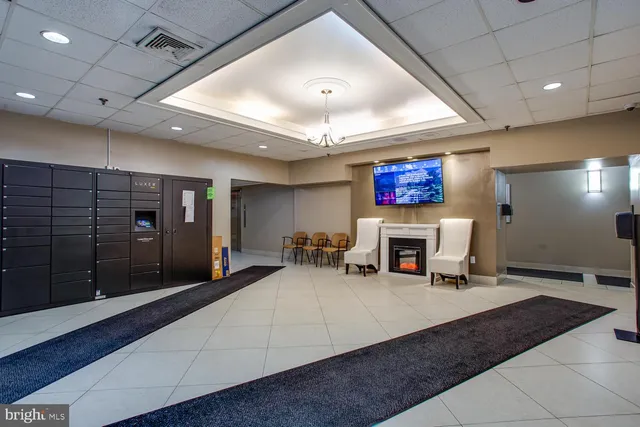 a lobby with furniture and a fireplace