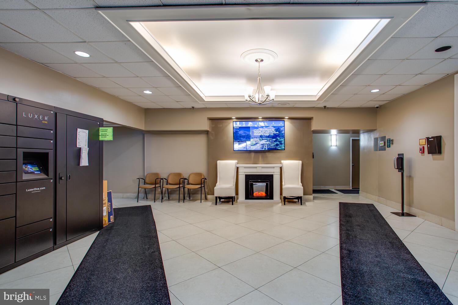 5911 Edsall Road, Unit 206 Alexandria, VA 22304 - Photo 38 of 40 a lobby with furniture and a fireplace