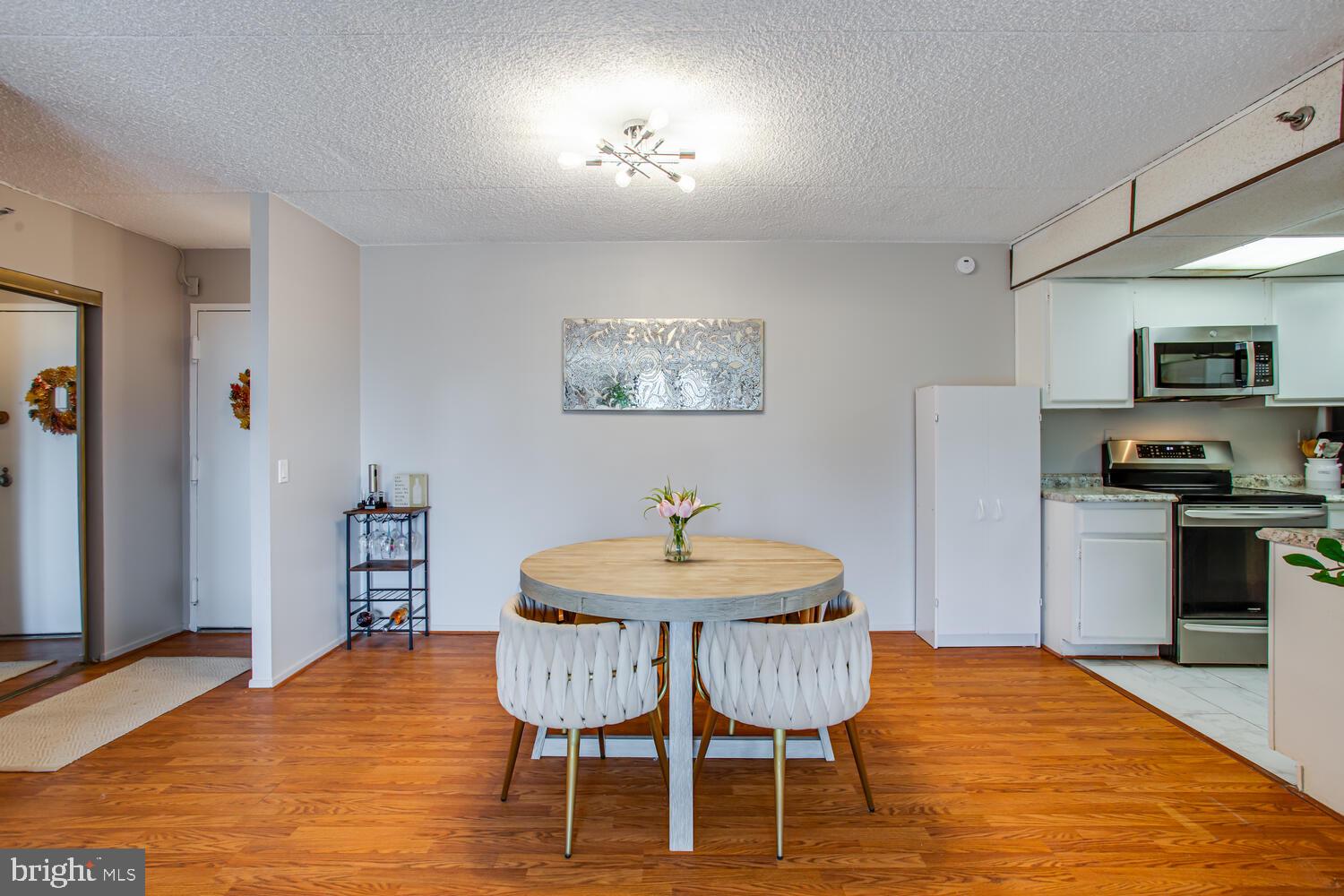 5911 Edsall Road, Unit 206 Alexandria, VA 22304 - Photo 5 of 40 a view of a dining room with furniture and wooden floor