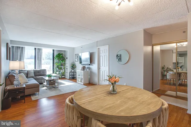a living room with kitchen island furniture and a large window