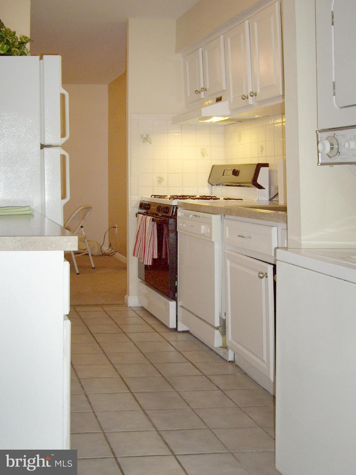 11212 Chestnut Grove Square, Unit 114 Reston, VA 20190 - Photo 11 of 18 a kitchen with a sink cabinets and appliances