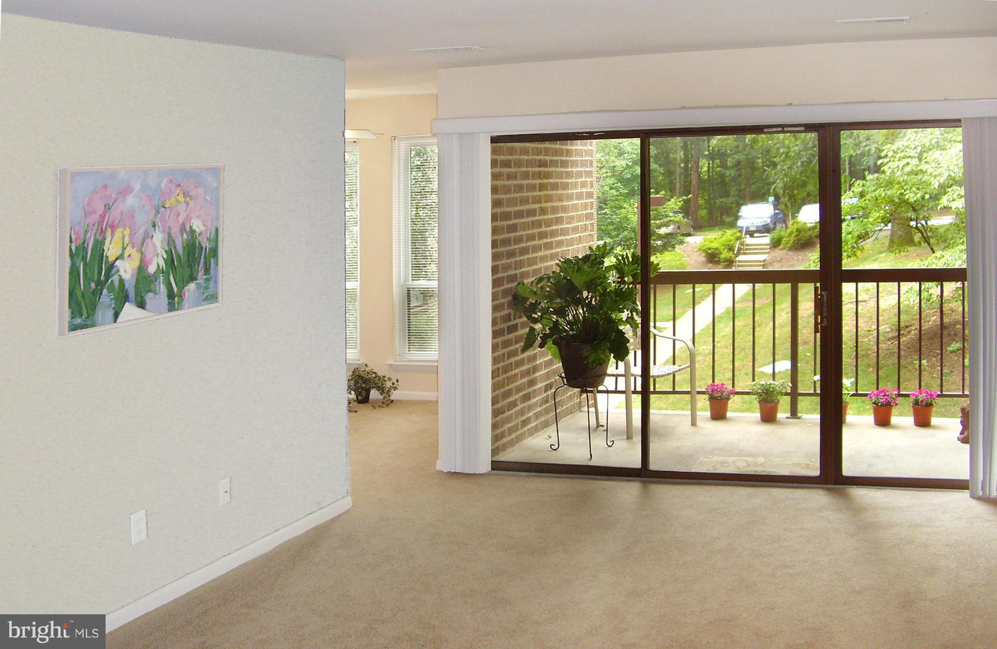 11212 Chestnut Grove Square, Unit 114 Reston, VA 20190 - Photo 4 of 18 a view of an empty room with a large window
